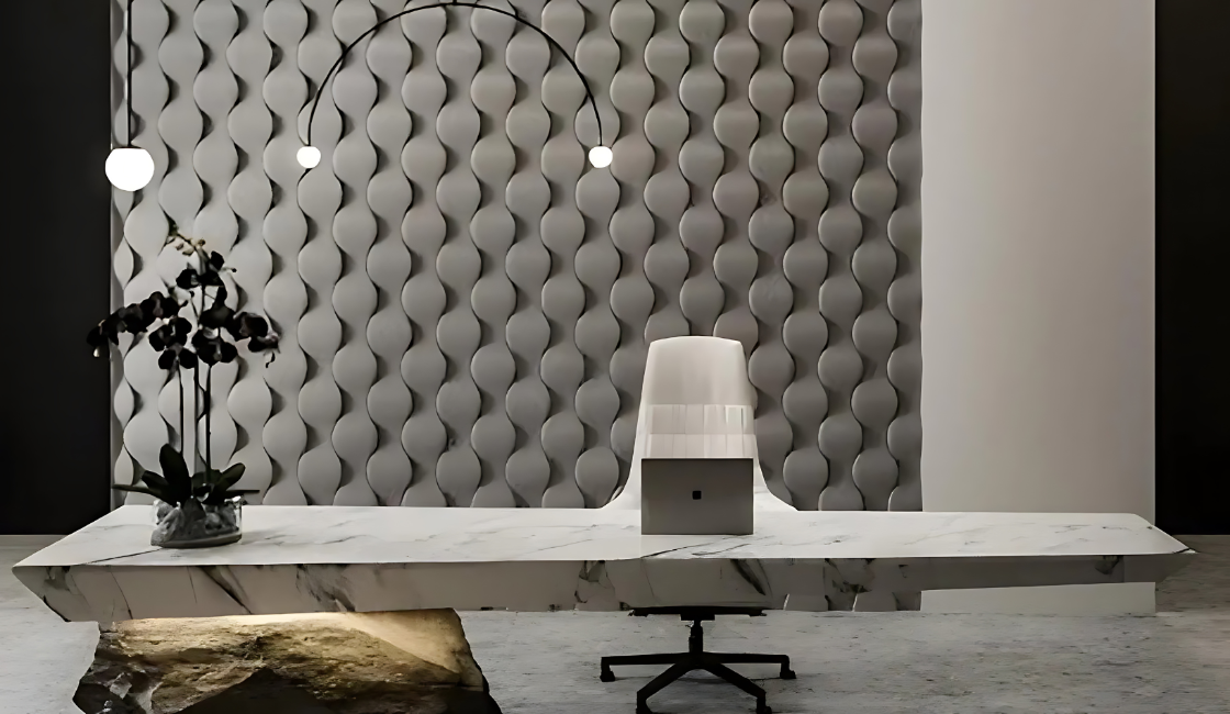 Elegant office interior featuring a striking 3D wall panel installation with an undulating gypsum pattern. These textured plaster panels from Kandes add depth and sophistication, complementing the marble desk and sculptural lighting. The non-combustible, eco-conscious design enhances the space with a modern yet organic aesthetic.