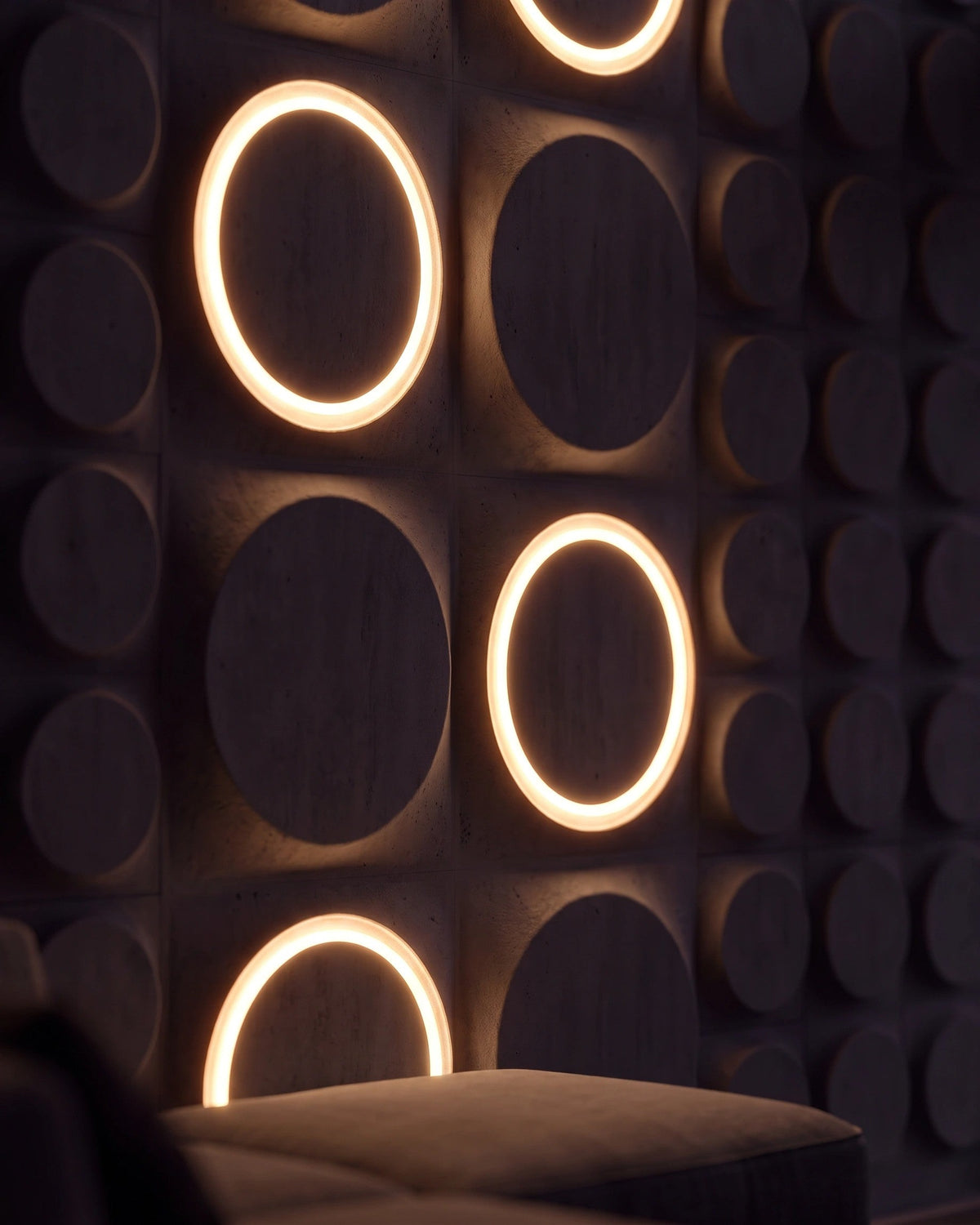 Close up of COSMIC 0012 LED gypsum 3D wall panels with illuminated rings at night