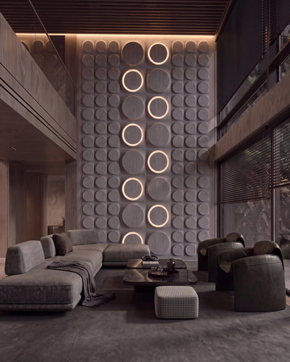 Kandes COSMIC 0012 gypsum 3D wall panels with LED halo rings on a double height living room wall at dusk
