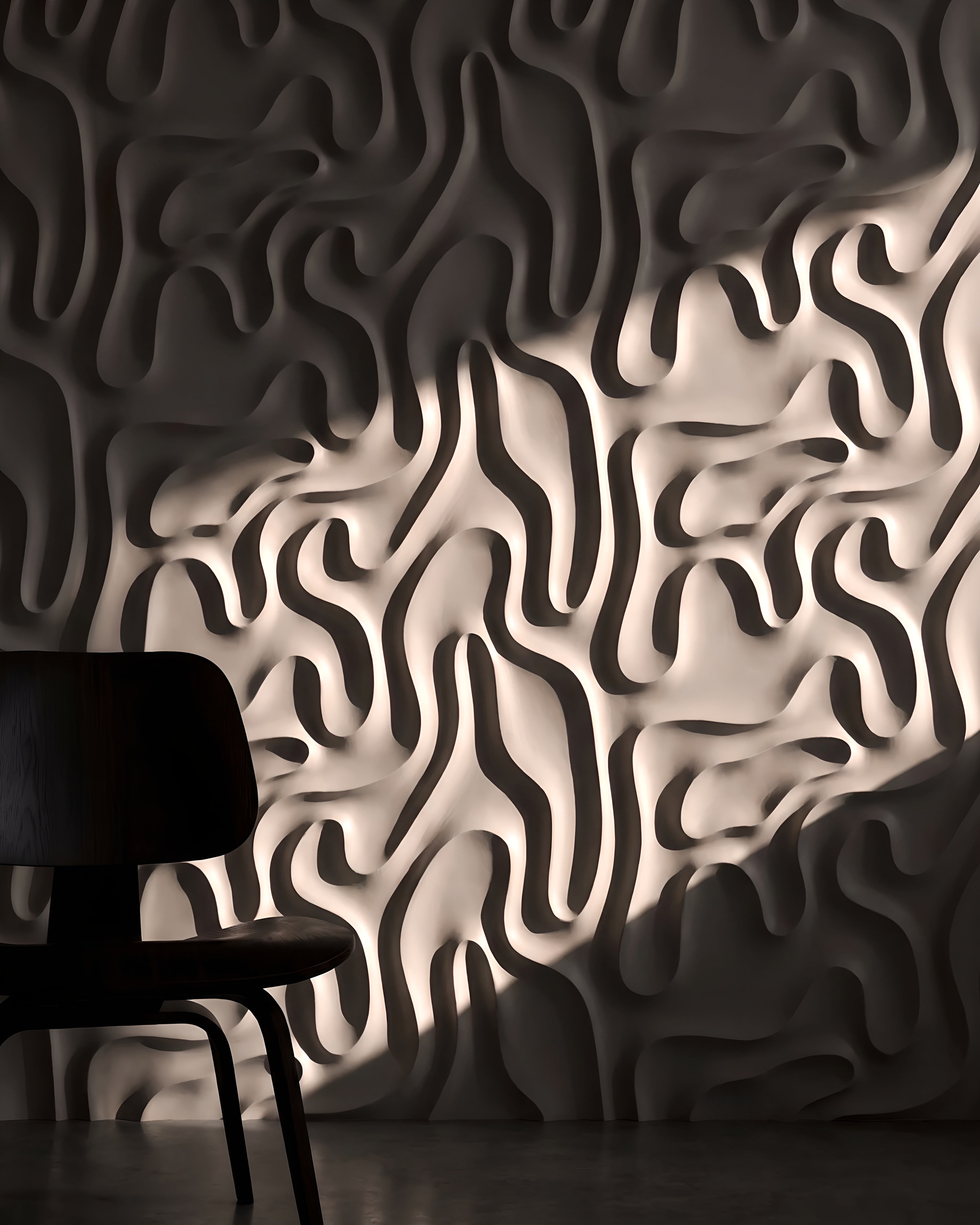 MYSTIC 0136 gypsum 3D wall panel relief in dramatic side light with a dark chair