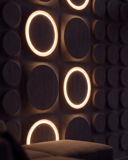 COSMIC 0212 LED gypsum 3D wall panels with lit rings seen from a sofa at night