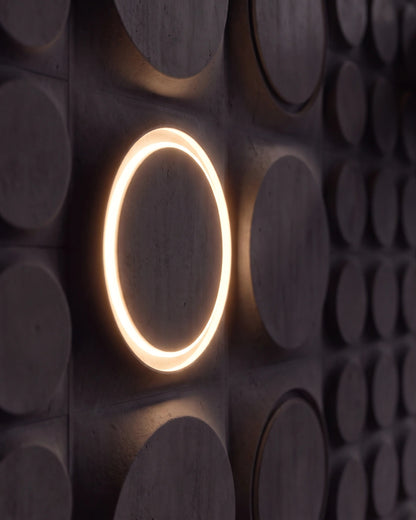 Single COSMIC 0212 LED gypsum 3D wall panel with warm halo ring in side view